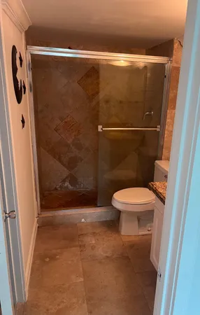a bathroom with a toilet and a shower