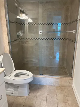 a bathroom with a toilet and a shower