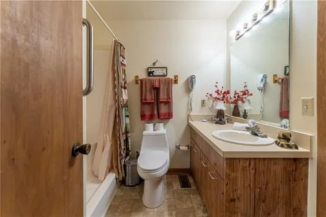 a bathroom with a sink toilet and shower
