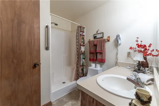 a bathroom with a sink toilet and shower
