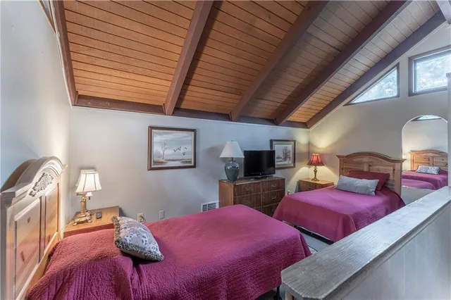 a bedroom with furniture and a flat screen tv