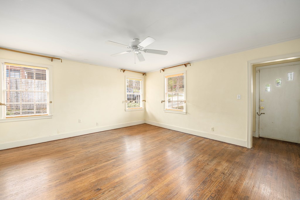 1620 Springer Street Columbus, GA 31901 - Photo 11 of 41 a view of an empty room with wooden floor and a window