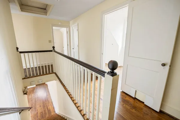 a view of staircase with railing and a window