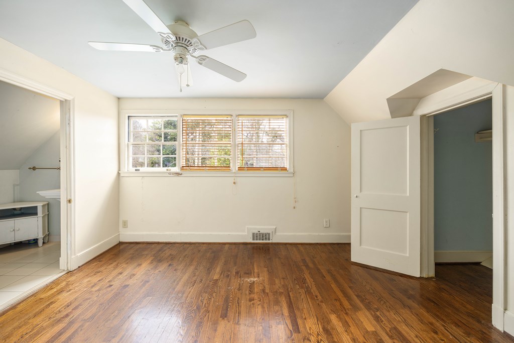 1620 Springer Street Columbus, GA 31901 - Photo 14 of 41 an empty room with wooden floor and windows