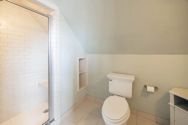 a white toilet sitting next to a bathroom sink