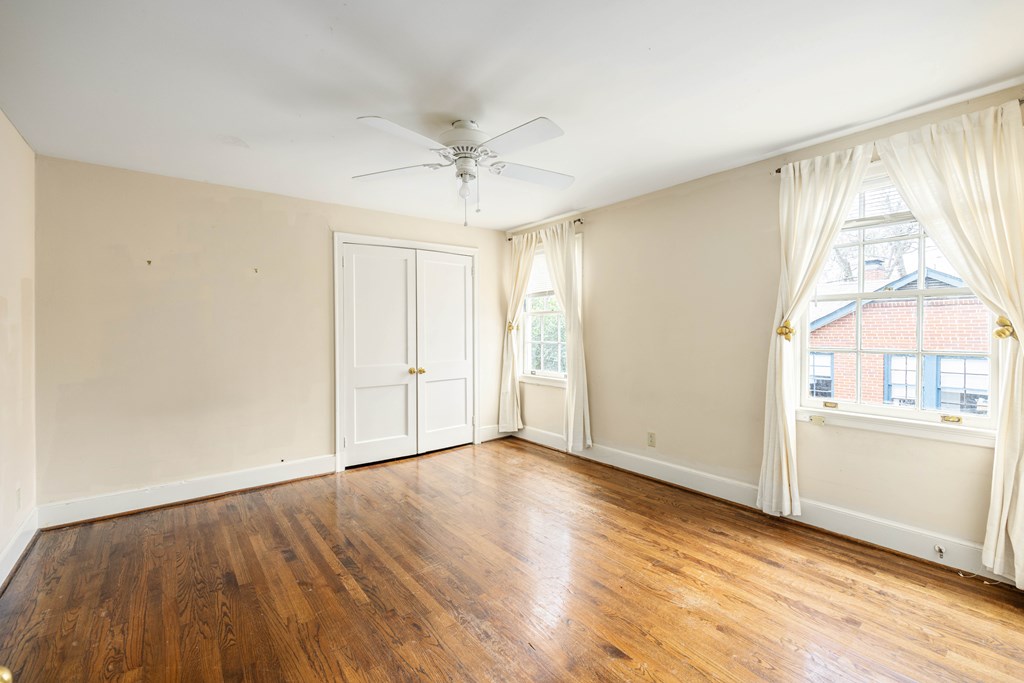 1620 Springer Street Columbus, GA 31901 - Photo 17 of 41 an empty room with wooden floor fan and windows