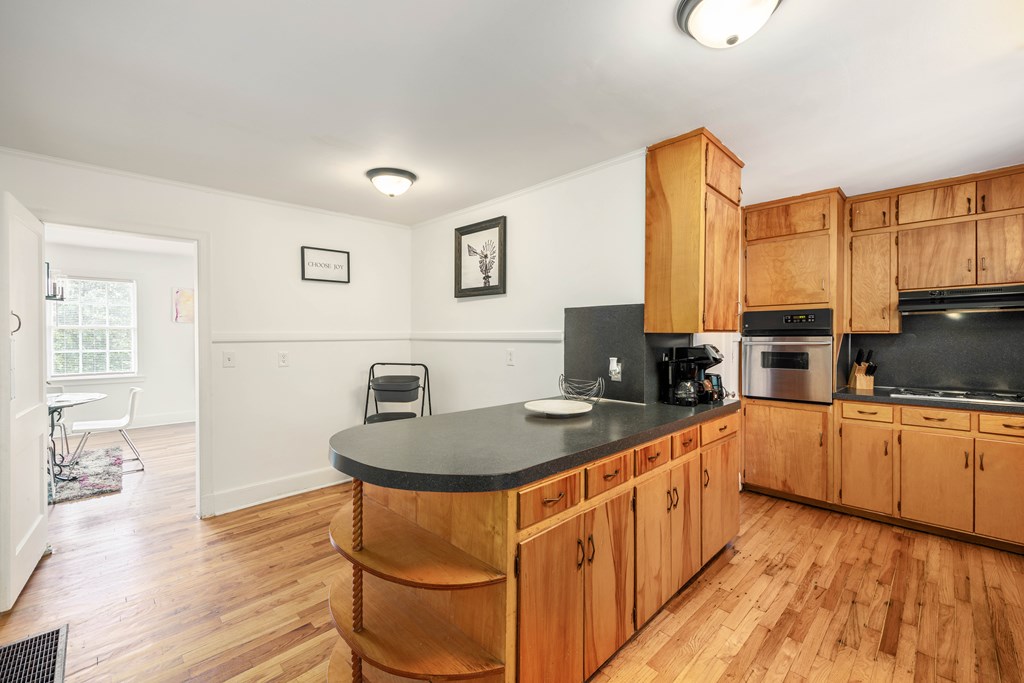 1620 Springer Street Columbus, GA 31901 - Photo 19 of 41 a kitchen with stainless steel appliances granite countertop a stove a sink and a refrigerator