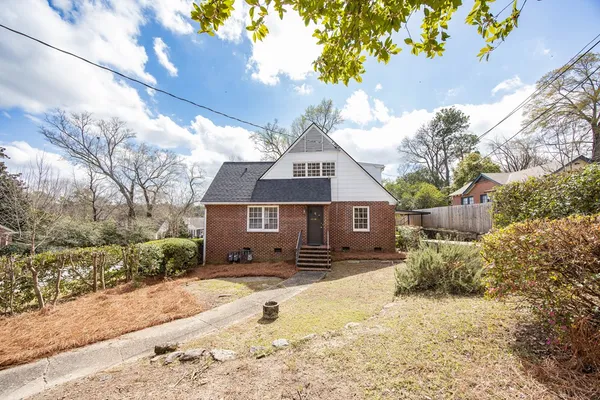 a front view of a house with a yard covered with snow in front of house