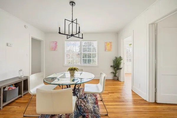 a view of a dining room with furniture window and wooden floor