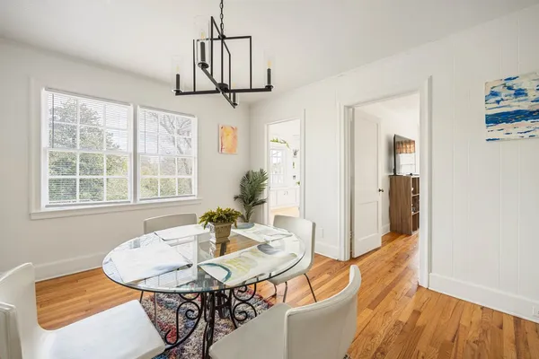 a view of a dining room with furniture window and wooden floor