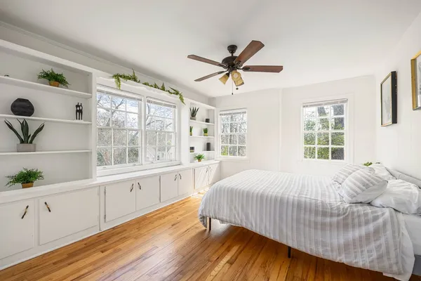 a bedroom with a large bed and a window
