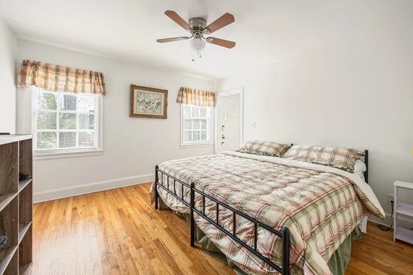 a bedroom with a bed and a large window with outer view