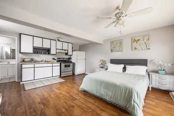 a large white kitchen with cabinets and stainless steel appliances