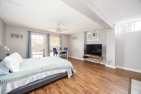 a bedroom with a bed and a flat screen tv