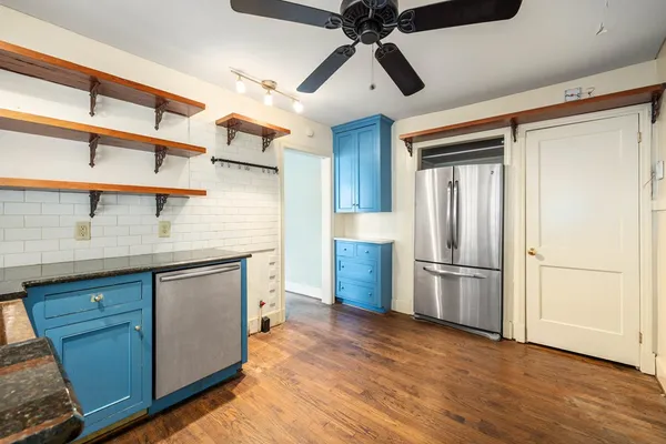 a kitchen with stainless steel appliances a refrigerator and a sink