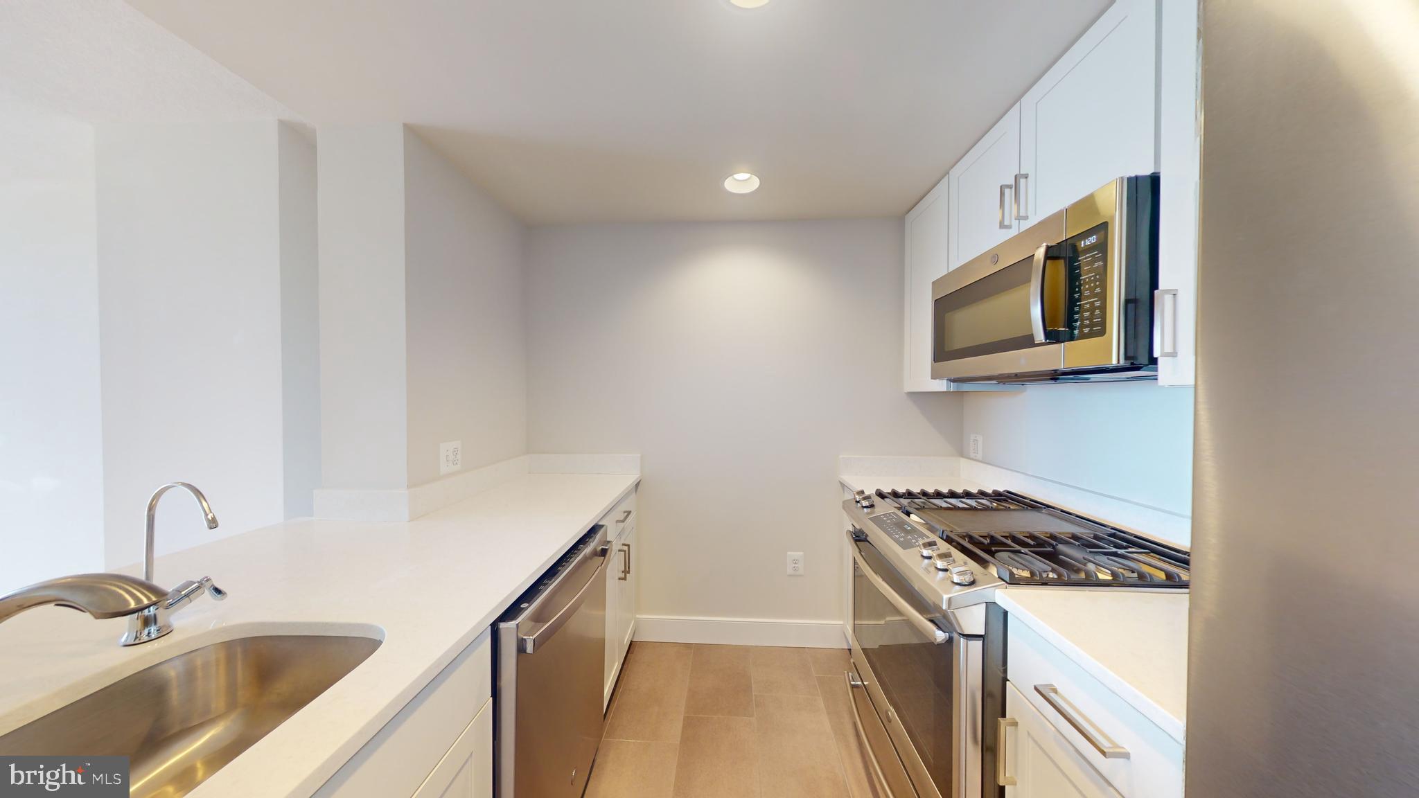 50 Florida Avenue Northeast, Unit 823 Washington, DC 20002 - Photo 5 of 12 a kitchen that has a sink and a stove