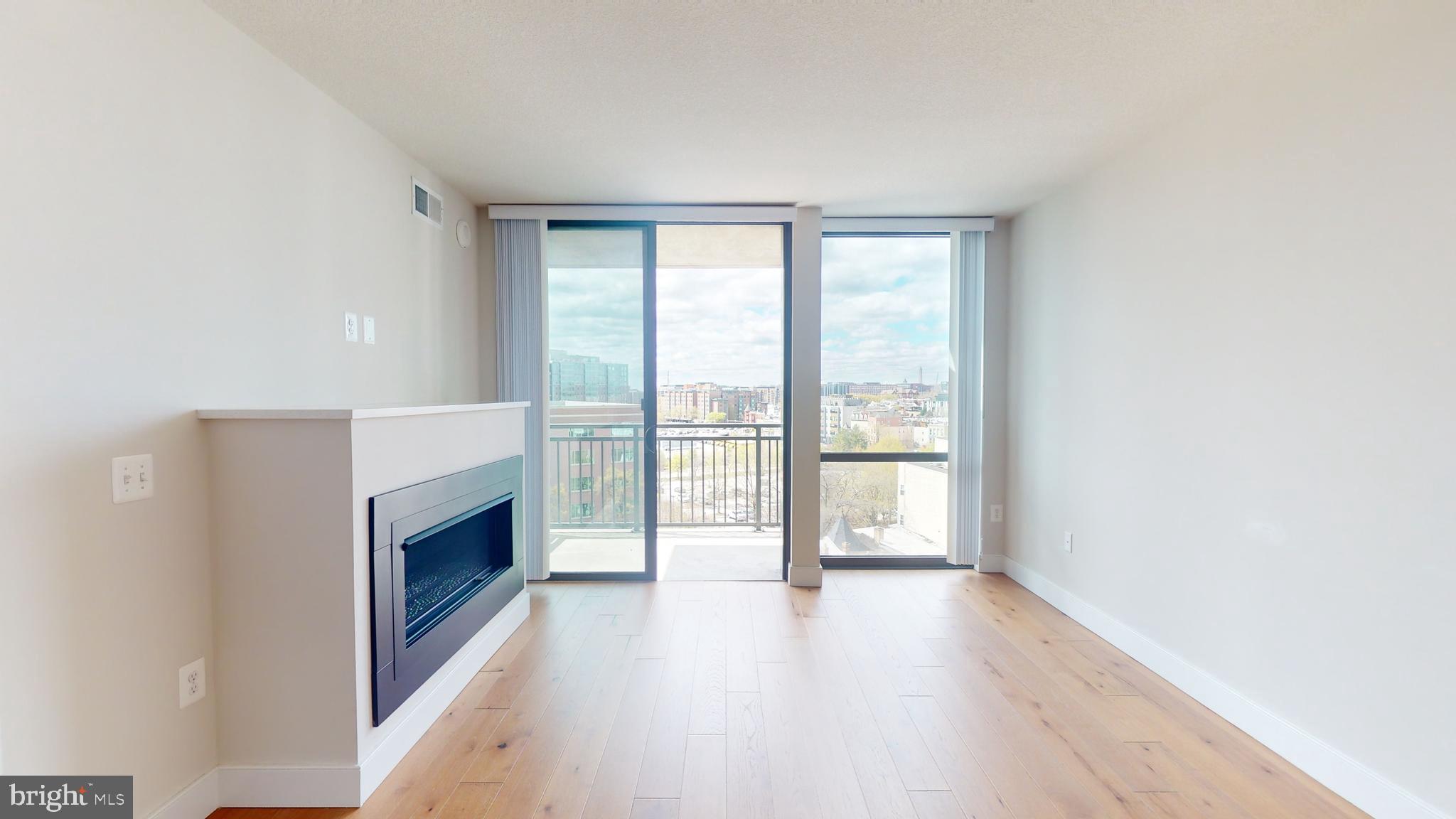50 Florida Avenue Northeast, Unit 823 Washington, DC 20002 - Photo 6 of 12 a view of an empty room with a fireplace and a window