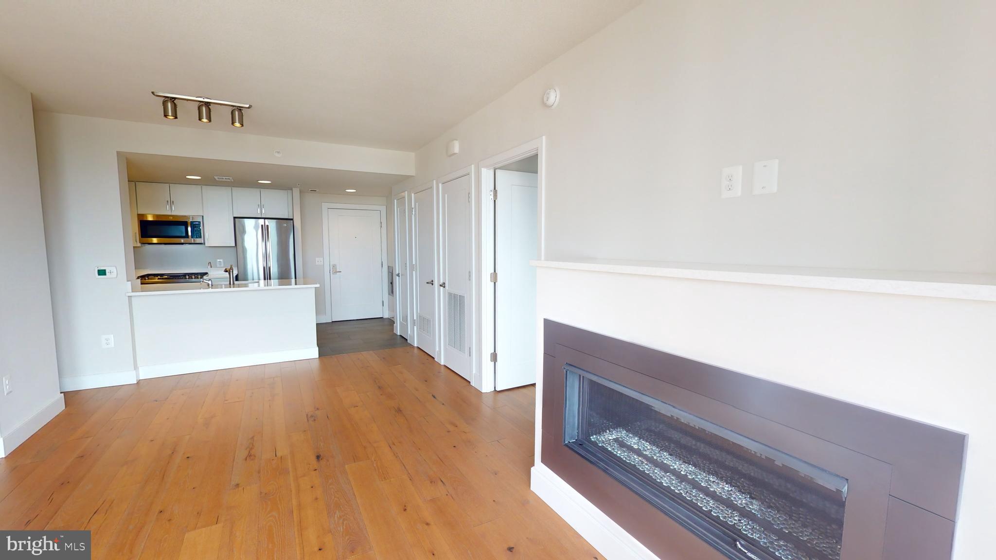 50 Florida Avenue Northeast, Unit 823 Washington, DC 20002 - Photo 7 of 12 a view of kitchen and empty room with wooden floor