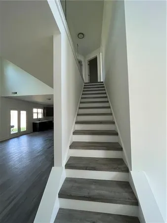 a view of entryway and hall with wooden floor