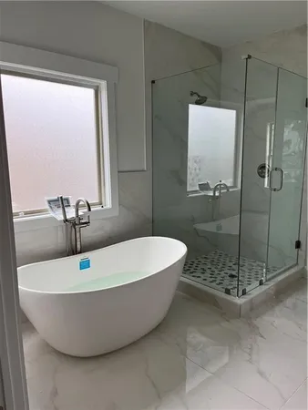 a bathroom with a bathtub and a shower