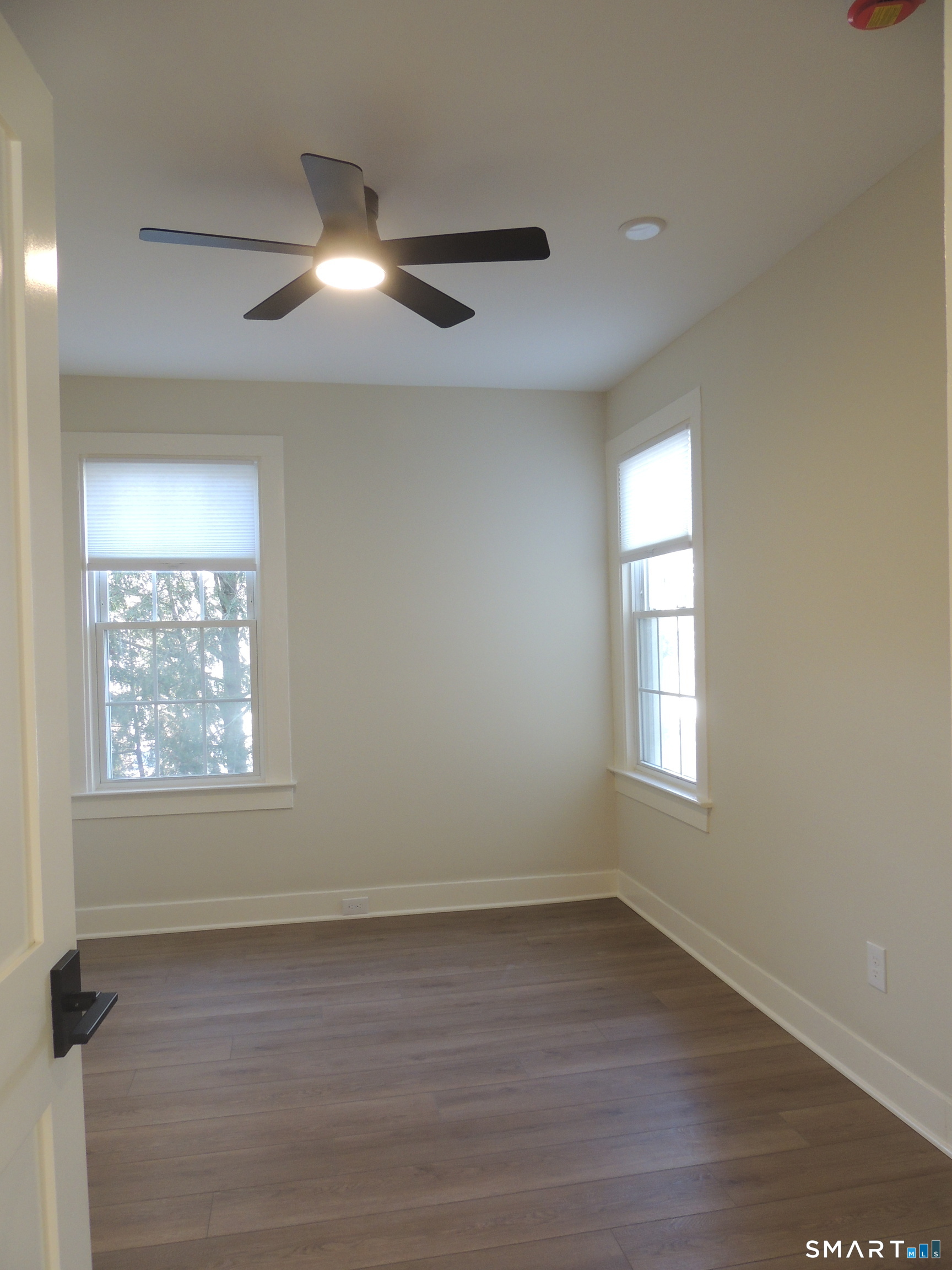 56-58 Harrison Avenue, Unit 2 Branford, CT 06405 - Photo 18 of 39 a view of an empty room with wooden floor and a window