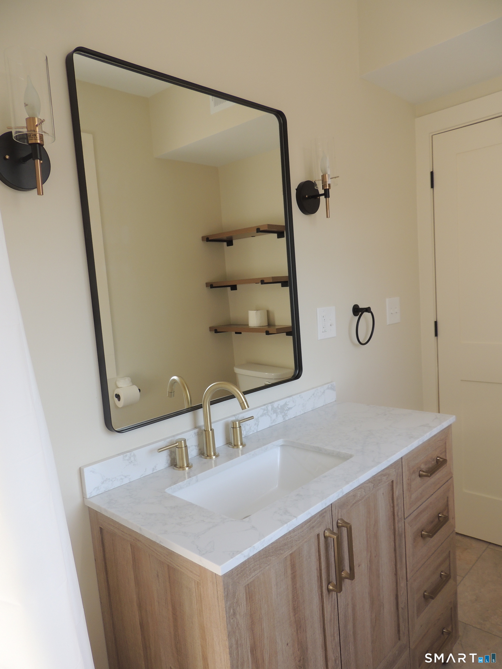 56-58 Harrison Avenue, Unit 2 Branford, CT 06405 - Photo 23 of 39 a bathroom with a sink and mirror