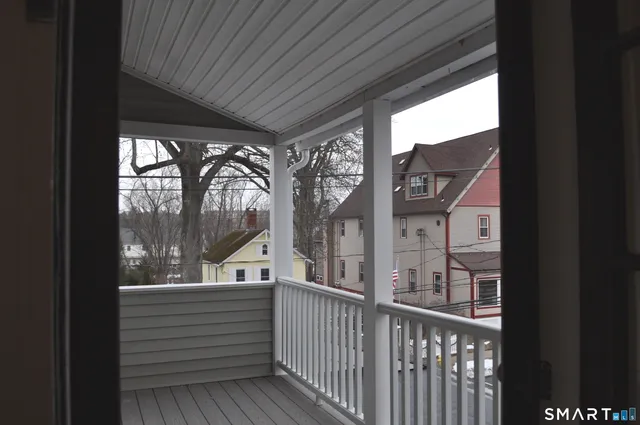 a front view of a house with cars parked