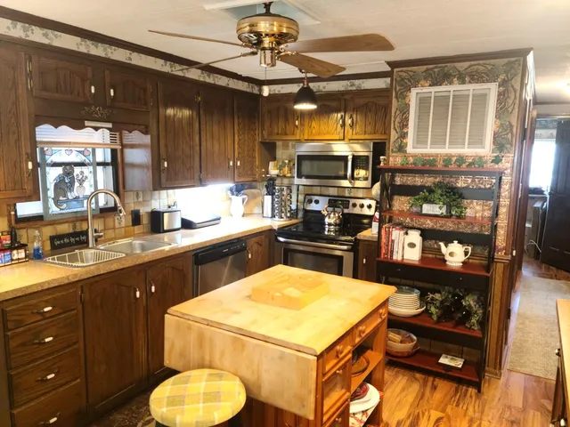 a kitchen with a sink appliances and cabinets