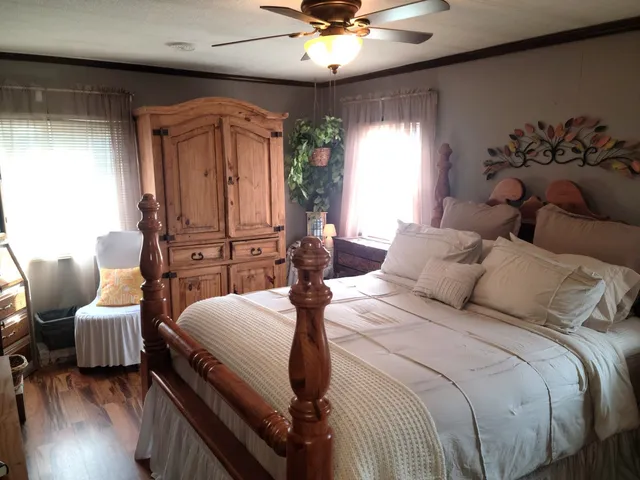 a bedroom with a bed and wooden floor