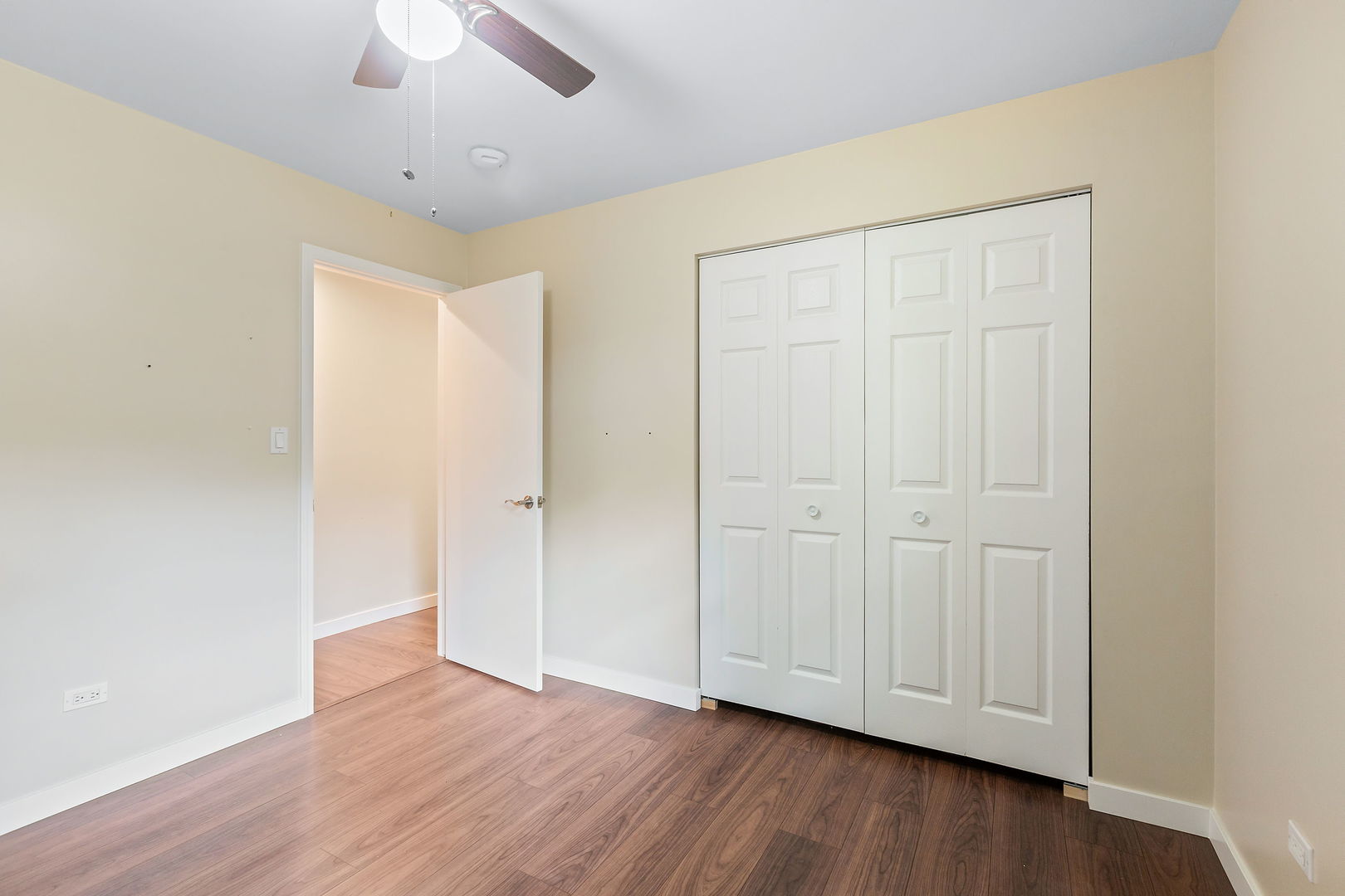 2404 George Street Rolling Meadows, IL 60008 - Photo 17 of 27 an empty room with wooden floor and ceiling fan