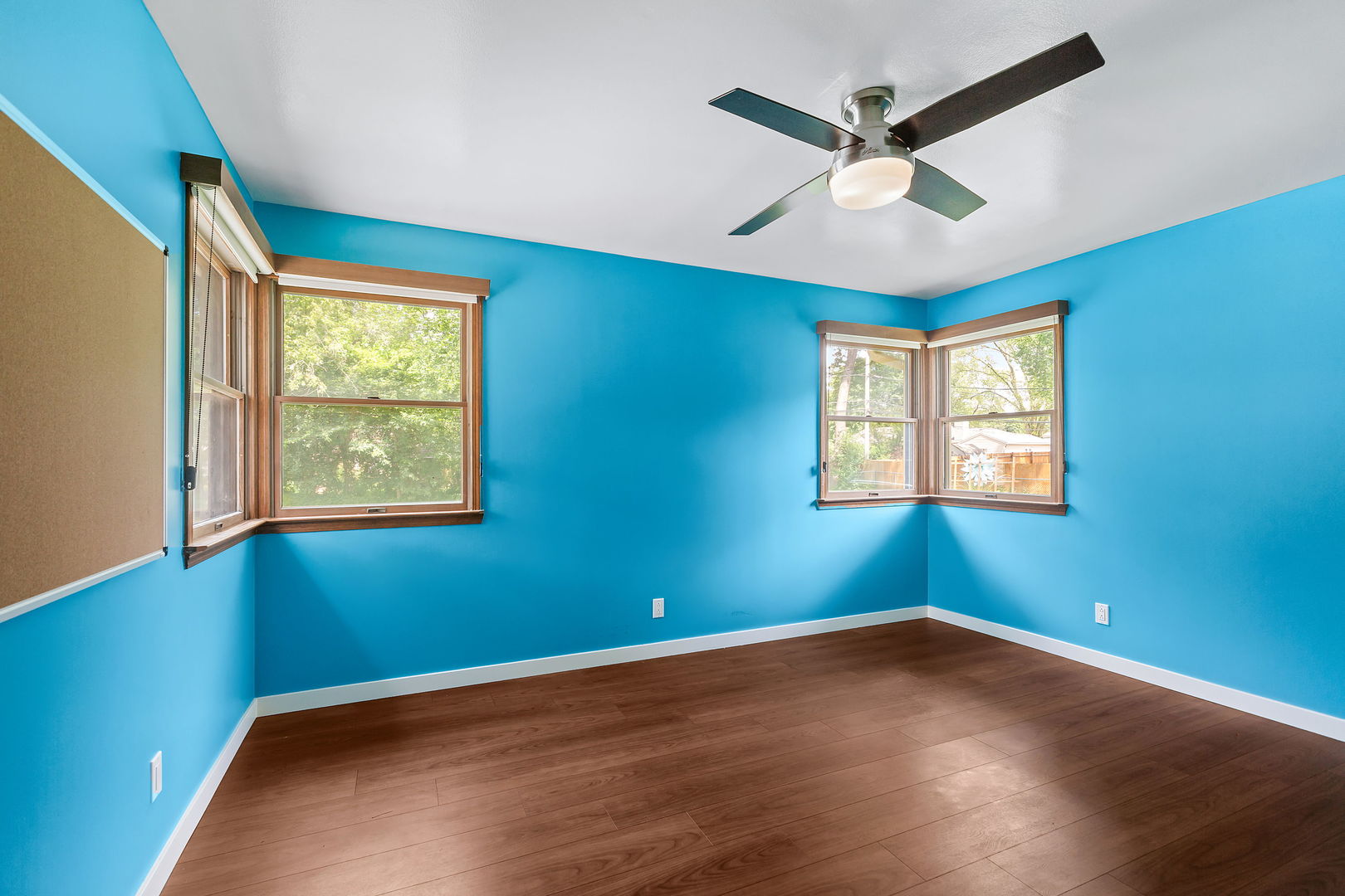 2404 George Street Rolling Meadows, IL 60008 - Photo 18 of 27 an empty room with wooden floor ceiling fan and windows