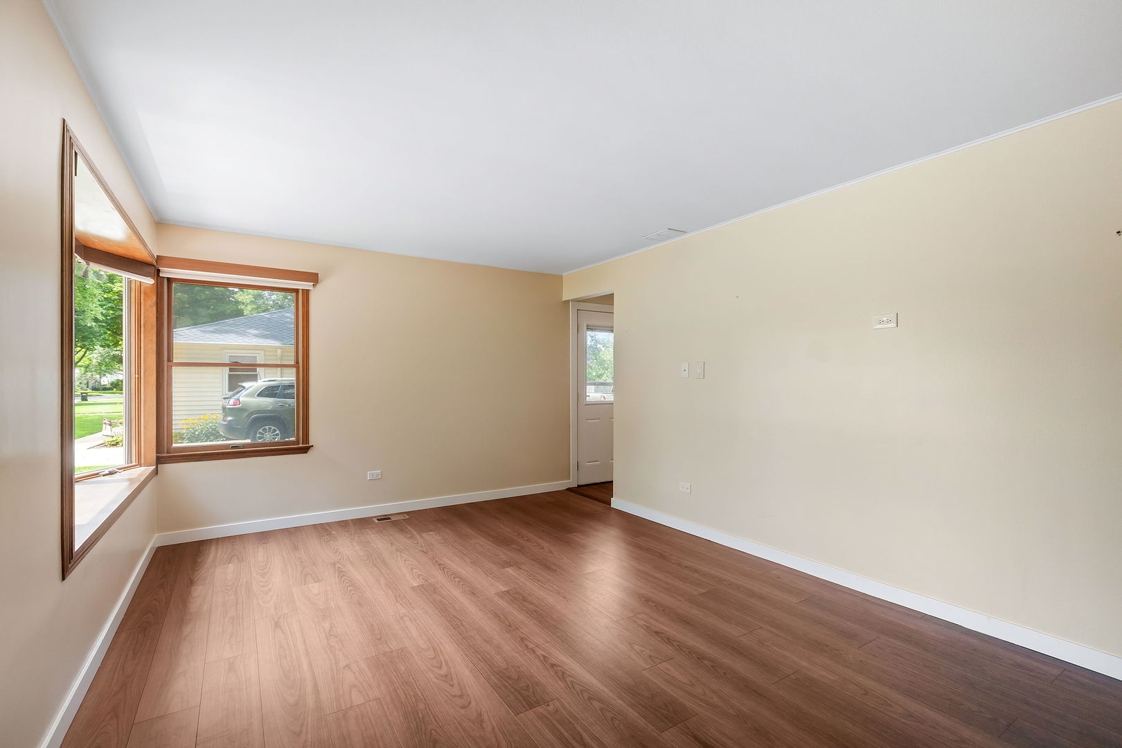 2404 George Street Rolling Meadows, IL 60008 - Photo 3 of 27 an empty room with wooden floor and windows