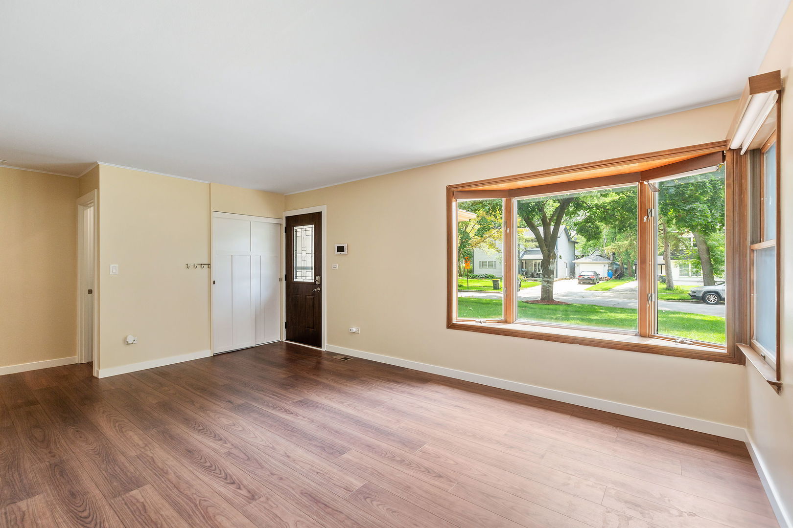 2404 George Street Rolling Meadows, IL 60008 - Photo 5 of 27 a view of an empty room with wooden floor and a window