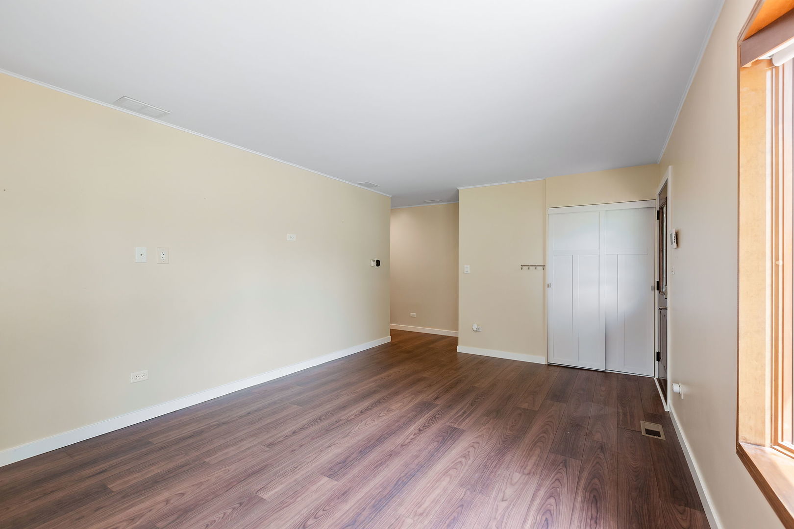 2404 George Street Rolling Meadows, IL 60008 - Photo 6 of 27 an empty room with wooden floor and windows