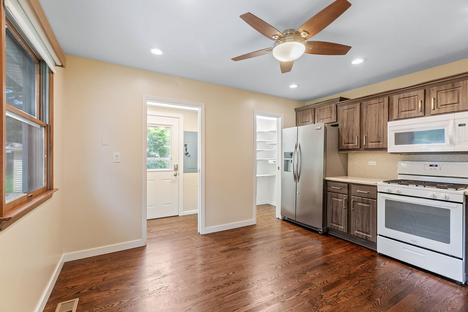 2404 George Street Rolling Meadows, IL 60008 - Photo 8 of 27 a kitchen with stainless steel appliances granite countertop a refrigerator a stove a sink and a window