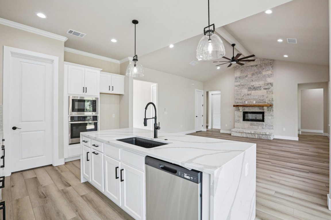 320 Yellow Ribbon Trail Burnet, TX 78611 - Photo 12 of 30 a kitchen with kitchen island a sink stainless steel appliances and wooden floor
