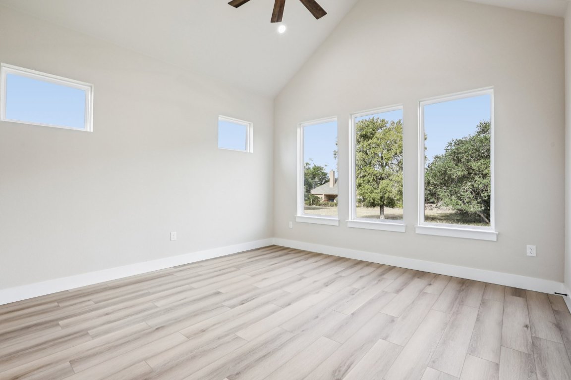 320 Yellow Ribbon Trail Burnet, TX 78611 - Photo 16 of 30 an empty room with wooden floor and windows