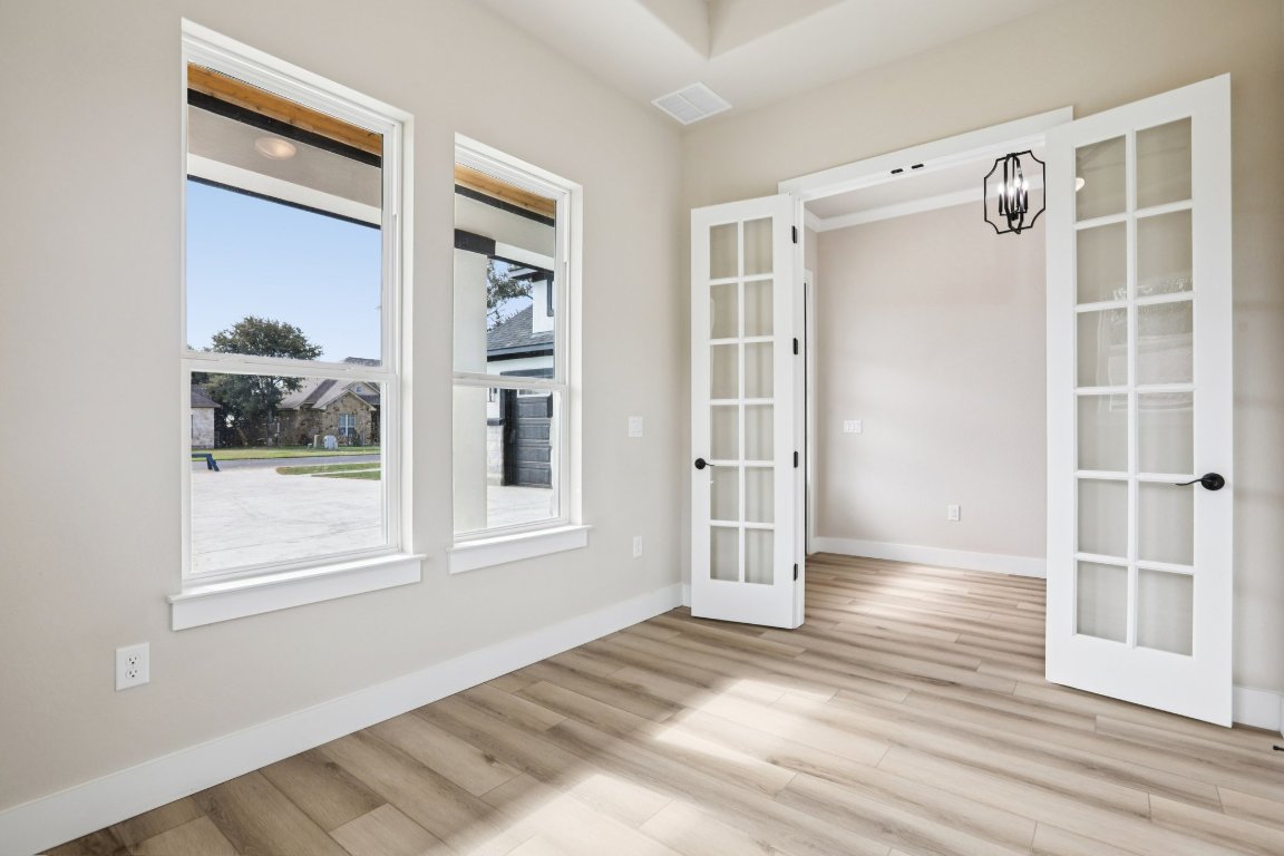 320 Yellow Ribbon Trail Burnet, TX 78611 - Photo 6 of 30 a view of an empty room with wooden floor and a window