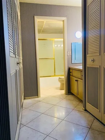 a bathroom with a mirror sink and tub