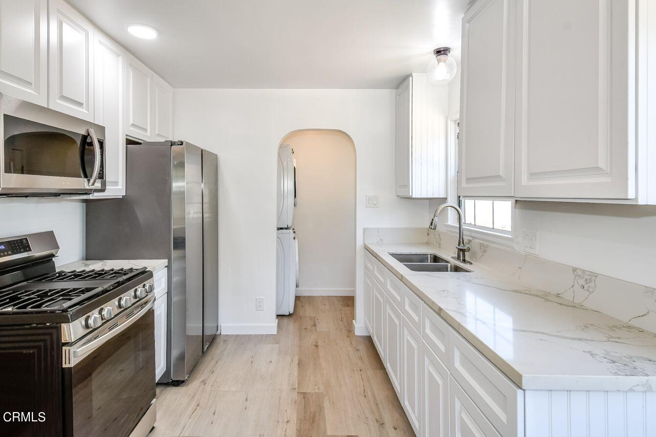 9730 1/2 Tujunga Canyon Boulevard Tujunga, CA 91042 - Photo 12 of 23 a kitchen with stainless steel appliances granite countertop a stove a sink and a refrigerator