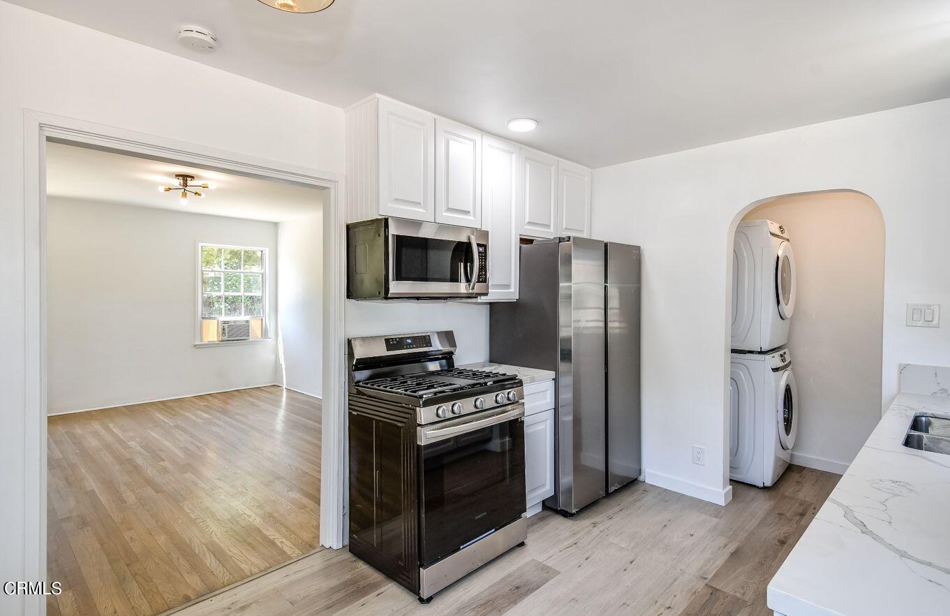 9730 1/2 Tujunga Canyon Boulevard Tujunga, CA 91042 - Photo 13 of 23 a kitchen with stainless steel appliances a refrigerator a stove a microwave and cabinets
