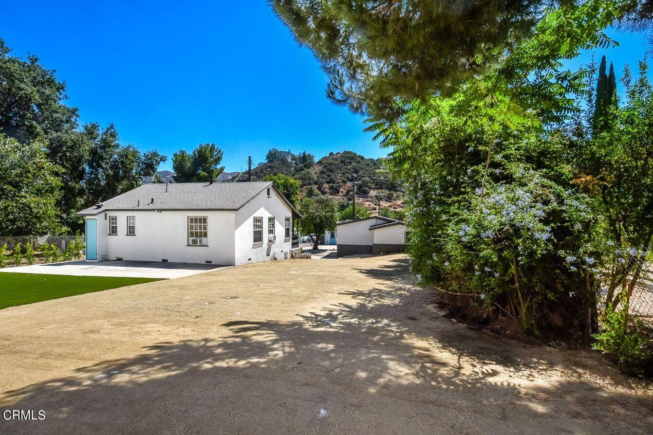 9730 1/2 Tujunga Canyon Boulevard Tujunga, CA 91042 - Photo 21 of 23 a front view of a house with a yard and garage