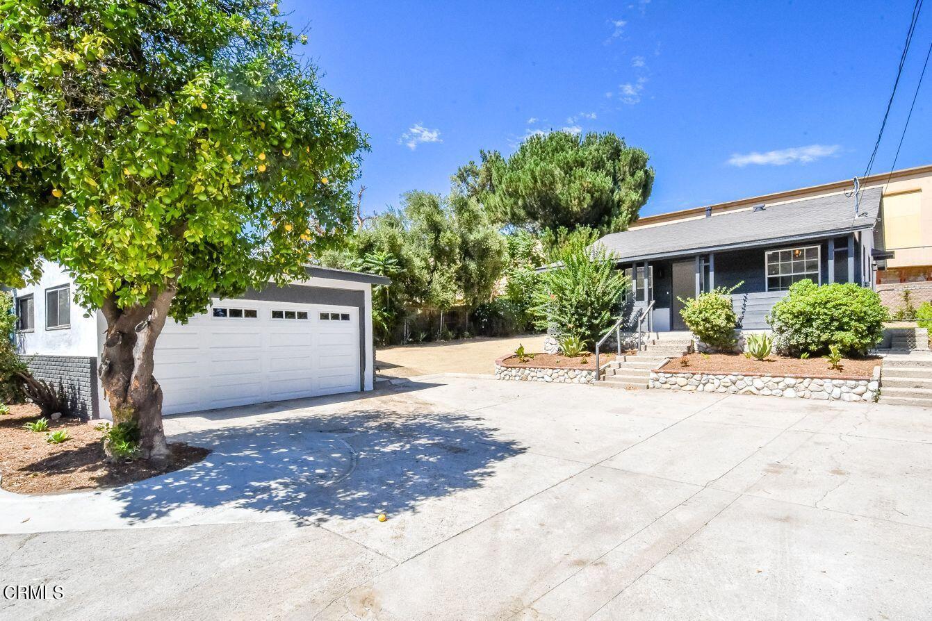 9730 1/2 Tujunga Canyon Boulevard Tujunga, CA 91042 - Photo 3 of 23 a front view of a house with a yard and a garage