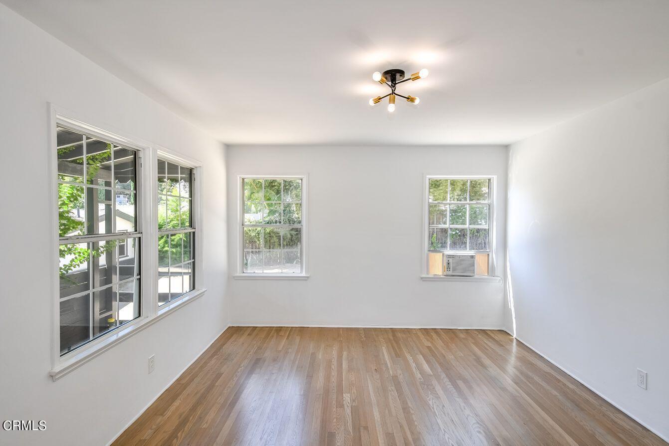 9730 1/2 Tujunga Canyon Boulevard Tujunga, CA 91042 - Photo 8 of 23 a view of an empty room with wooden floor and a window