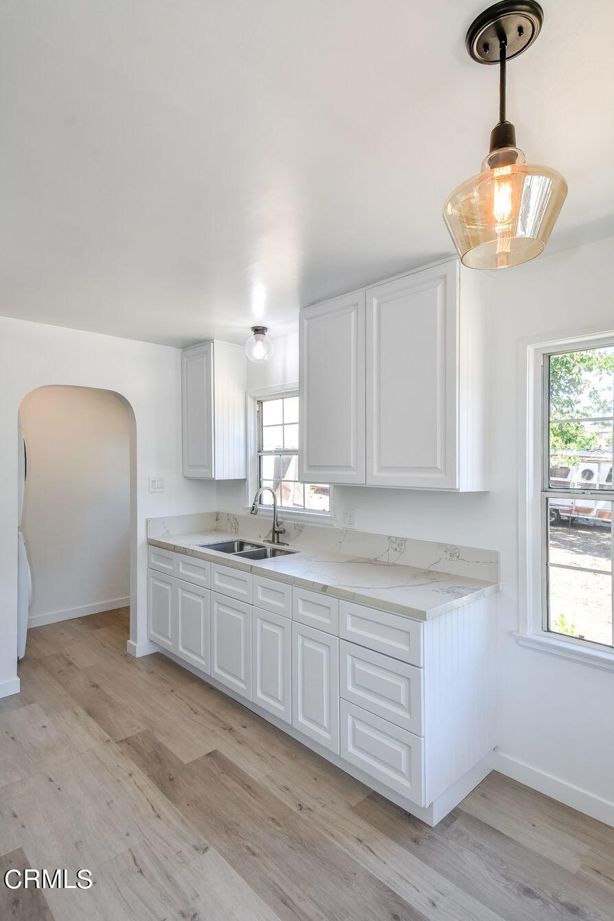 9730 1/2 Tujunga Canyon Boulevard Tujunga, CA 91042 - Photo 10 of 23 a large kitchen with stainless steel appliances granite countertop a sink and dishwasher a stove with wooden floor