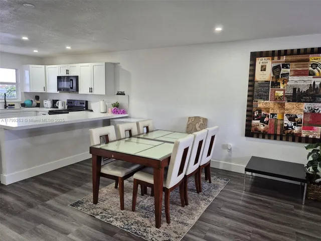 a view of a dining room with furniture and wooden floor