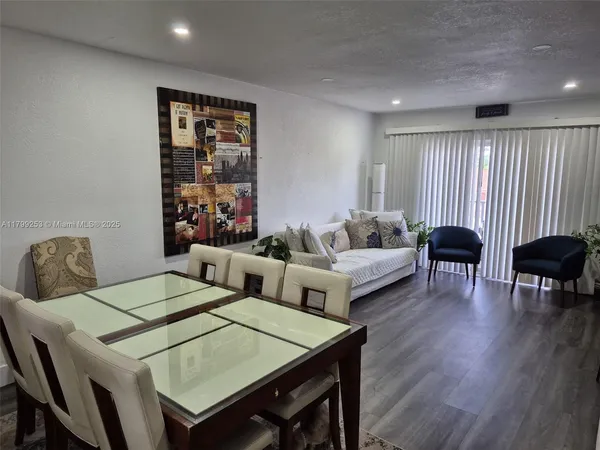 a view of a dining room with furniture and wooden floor