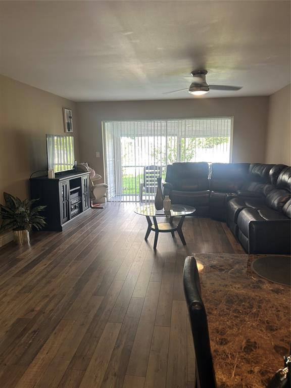 3521 Inverrary Drive, Unit J109 Lauderhill, FL 33319 - Photo 2 of 15 a living room with furniture and a wooden floor