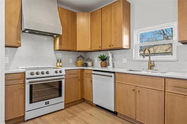 a kitchen with cabinets appliances and a sink