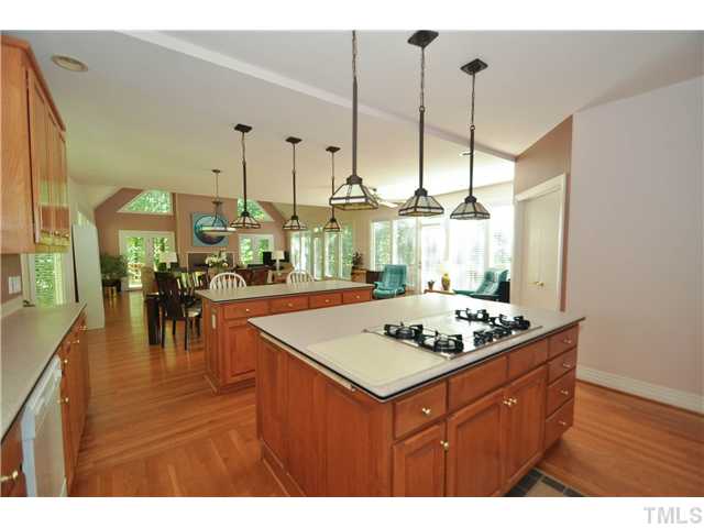 6424 Rushingbrook Drive Raleigh, NC 27612 - Photo 6 of 25 a kitchen with a stove a counter top space and living room view